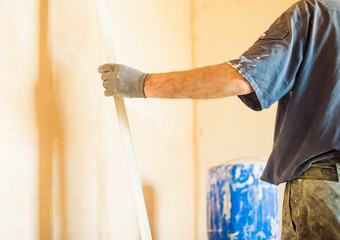 Wall Mural - man working with trowel on home walls