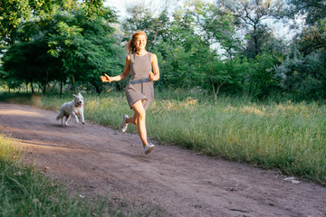 Wall Mural - girl playing with labrador retriever dog in park