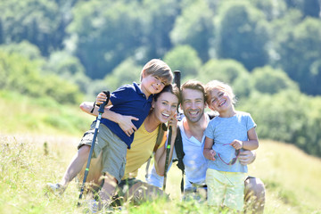 portrait of happy family on a hiking day in the mountain