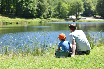 Wall Mural - Dad with little boy fishing by mountain lake