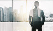 silhouette of business man over office background