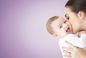 happy mother kissing adorable baby
