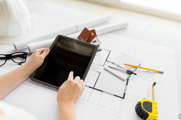 Poster - close up of hand with blueprint and tablet pc