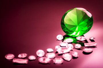 Giant green emerald on a red/ pink background surrounded by precious diamonds leading into the image