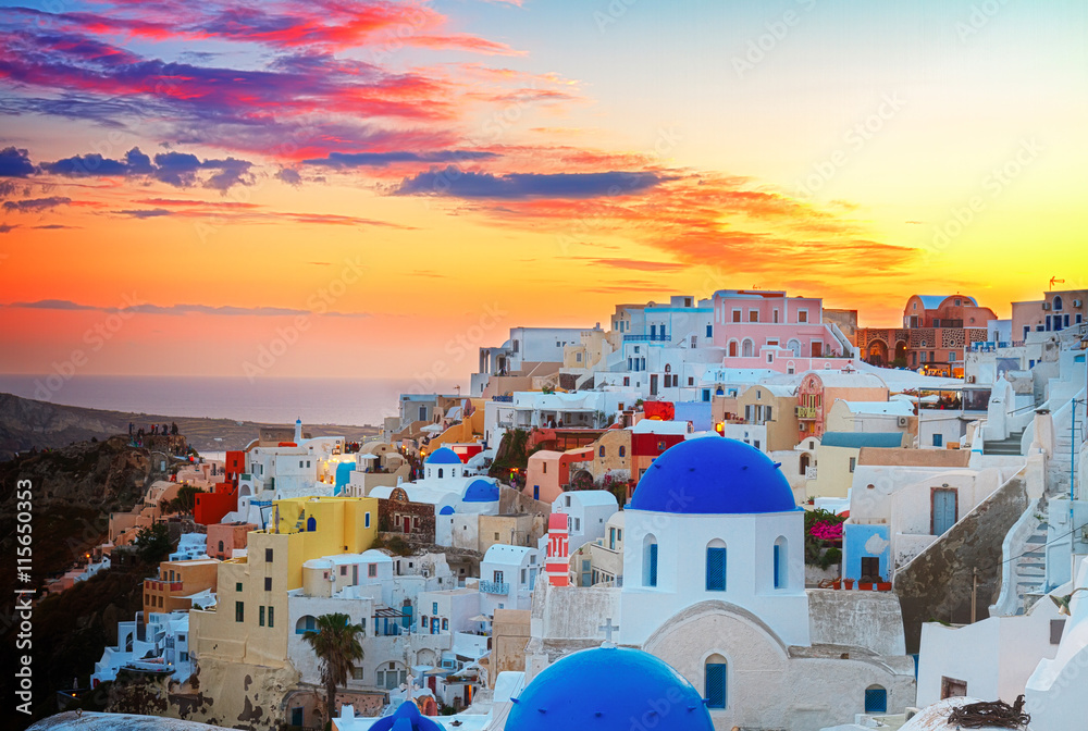 cityscape of Oia, traditional greek village of Santorini,  with blue domes of churches at sunset, Greece, toned - obrazy, fototapety, plakaty 