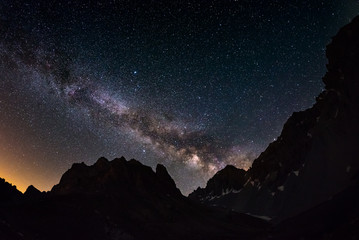 The outstanding beauty of the Milky Way arc and the starry sky captured at high altitude in summertime on the Italian Alps, Torino Province. Fisheye scenic distortion and 180 degree view.