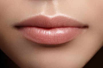 Perfect natural lip makeup. Close up macro photo with beautiful female mouth. Plump full lips. Close-up face detail. Perfect clean skin, light fresh lip make-up. Beautiful spa tender lip

