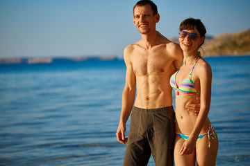 Wall Mural - young happy couple walking on the beach at the sunset. Balos beach, Crete, Greece.