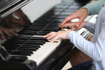 Canvas Print - Small girl learning play piano with teacher