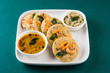 south indian favourite food rava idli or semolina idly or rava idly, served with sambar and green chutney