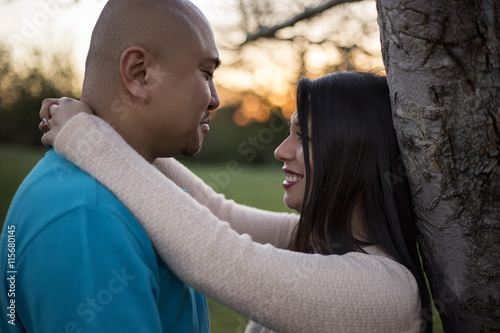 Fotografie, Obraz Young latino couple on a romantic date at a park during sunset