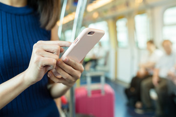 Poster - Woman using cellphone inside train compartment