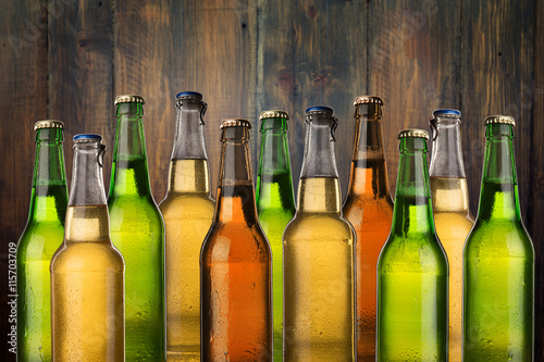 Obraz w ramie Group of cold wet beer bottles on the grunge background