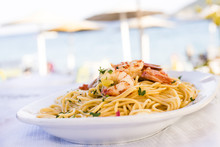 Plate Of Sea Food, Spicy Pasta With Shrimps Served On The Beach Restaurant