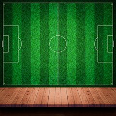 Poster - Empty wooden table or counter with football field wall backgroun