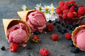 Poster - Raspberry ice cream with ice cream cones on stone table.