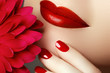 © looking2thesky - Beauty fashion model woman face. Beautyportrait with pink flower. Red lips and nails. Beautiful woman with luxury make-up and perfect manicure
