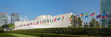Fototapeta Tulipany - UN United Nations general assembly building with world flags fly - 3:1 aspect ratio