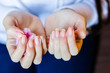 Woman with long red nails removing nail polish at home, close up photo