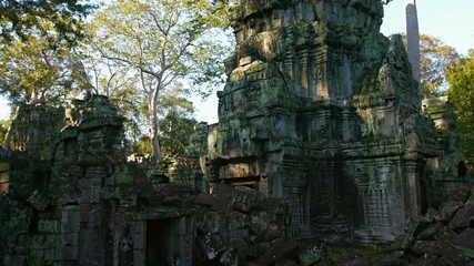 Canvas Print - Heaps of fallen, stone blocks and remaining walls of Ta Prohm Temple Ruin, an important historical site near Siem Reap, Cambodia. Video 4k