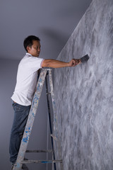 Sticker - worker use brush for color paint concrete Loft style on wall