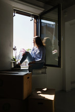 Woman Sitting By Window