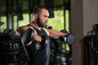 Bodybuilder Exercise Shoulders With Dumbbells