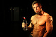 © kazanovskyiphoto - Young handsome muscular man with bottle of water