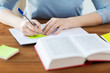© Syda Productions - close up of student with book and notebook at home