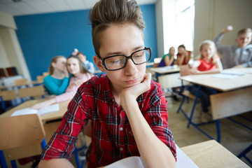 students gossiping behind classmate back at school