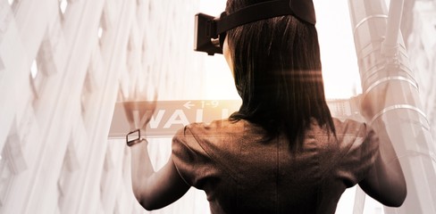 Poster - composite image of woman using a virtual reality device