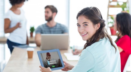 Poster - Composite image of smiling businesswoman using tablet 