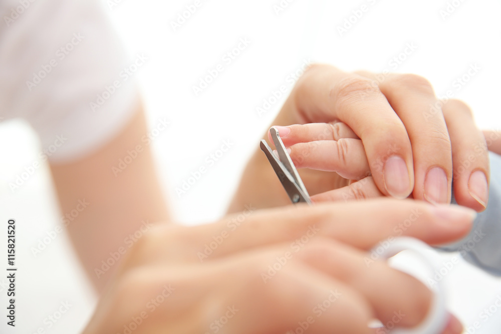 Mother cutting kids nails