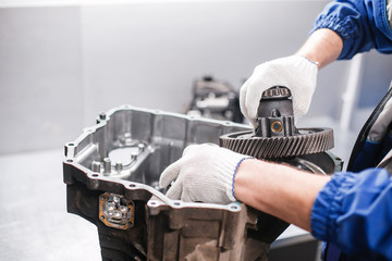 cross-section of a car gearbox. mechanics work in the garage