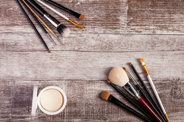 On top view of make up brushes and cosmetics products