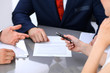 © rogerphoto - Business lady offering businessman black pen for signing a contract