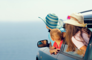 Mother with two kids travel by car on sea vacation, selective fo