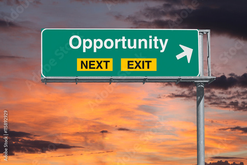 Fotografía Opportunity Next Exit Freeway Sign with Sunrise Sky