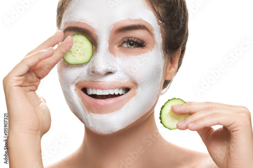 Woman with facial mask and cucumber slices in her hands Plakat