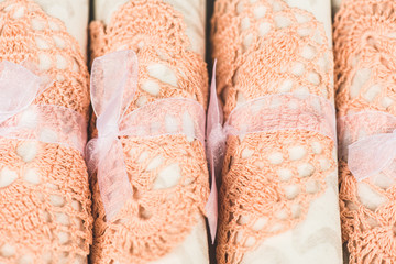 Wall Mural - White napkins in pink napkin vintage ring sitting on a plate. Linen textile background. Shallow DOF.