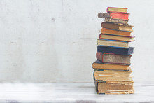 Stack Of Books On White Wooden Background
