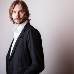 Wall Mural - Elegant young long hair handsome man pose in studio.