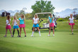 © BestStockFoto - Group of young female golf caddies on golf course.