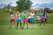 © BestStockFoto - Group of young female golf caddies on golf course.