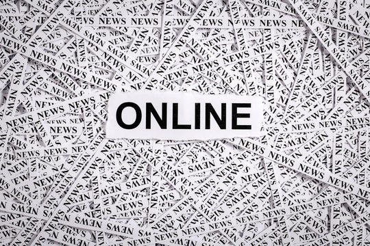 Closeup torn pieces and tapes of paper with the word ONLINE.