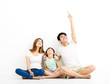 © Tom Wang - Happy  Young  Family pointint and looking up