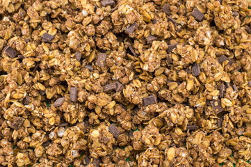 Healthy granola muesli cereals with chocolate background