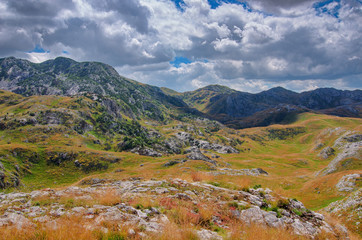 Poster - Montenegro, national park Durmitor, mountains and clouds panorama. Sunlight lanscape. Nature travel background.