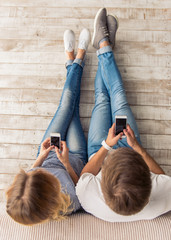 Wall Mural - Beautiful young couple with gadget