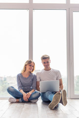 Wall Mural - Beautiful young couple with gadget